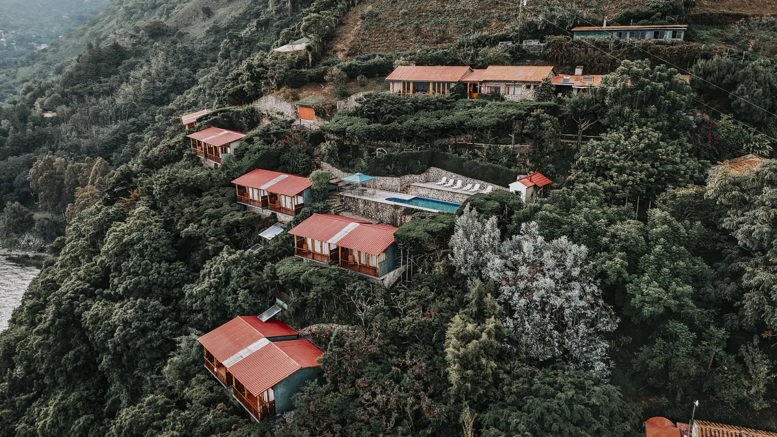 Aerial drone view of Loma de Atitlan wellness retreat on the hillside shores of Lake Atitlan, Guatemala