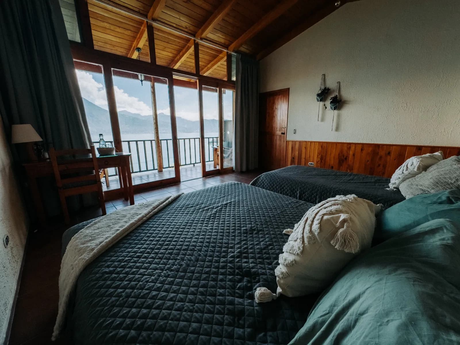 Natural wood bungalow room at Loma de Atitlan