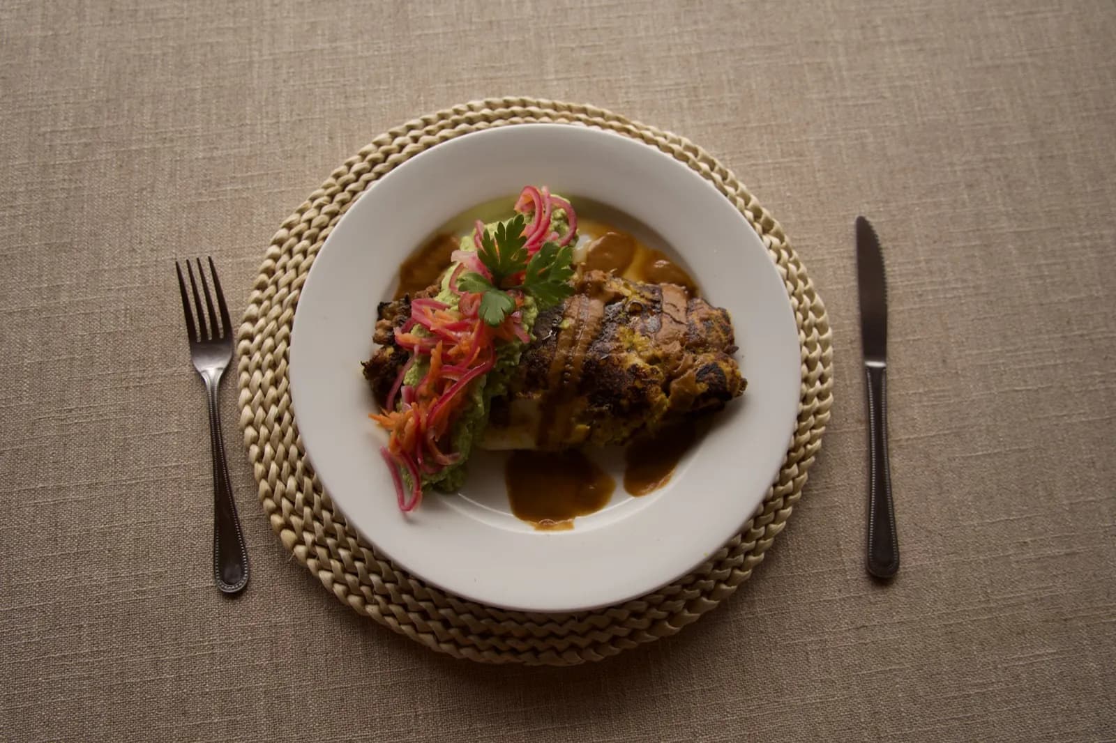 Beautifully plated main course on woven placemat