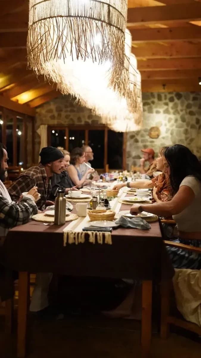 A candlelit community dinner at the long table at Loma de Atitlán