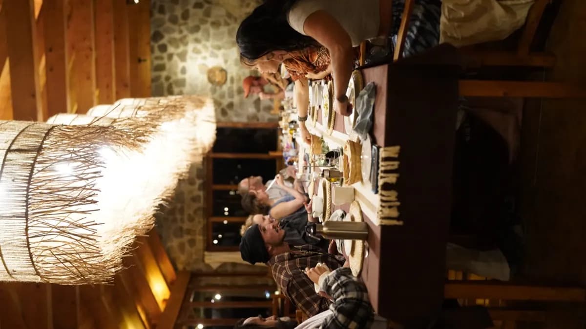 Guests sharing a community-style dinner at the long table at Loma de Atitlán