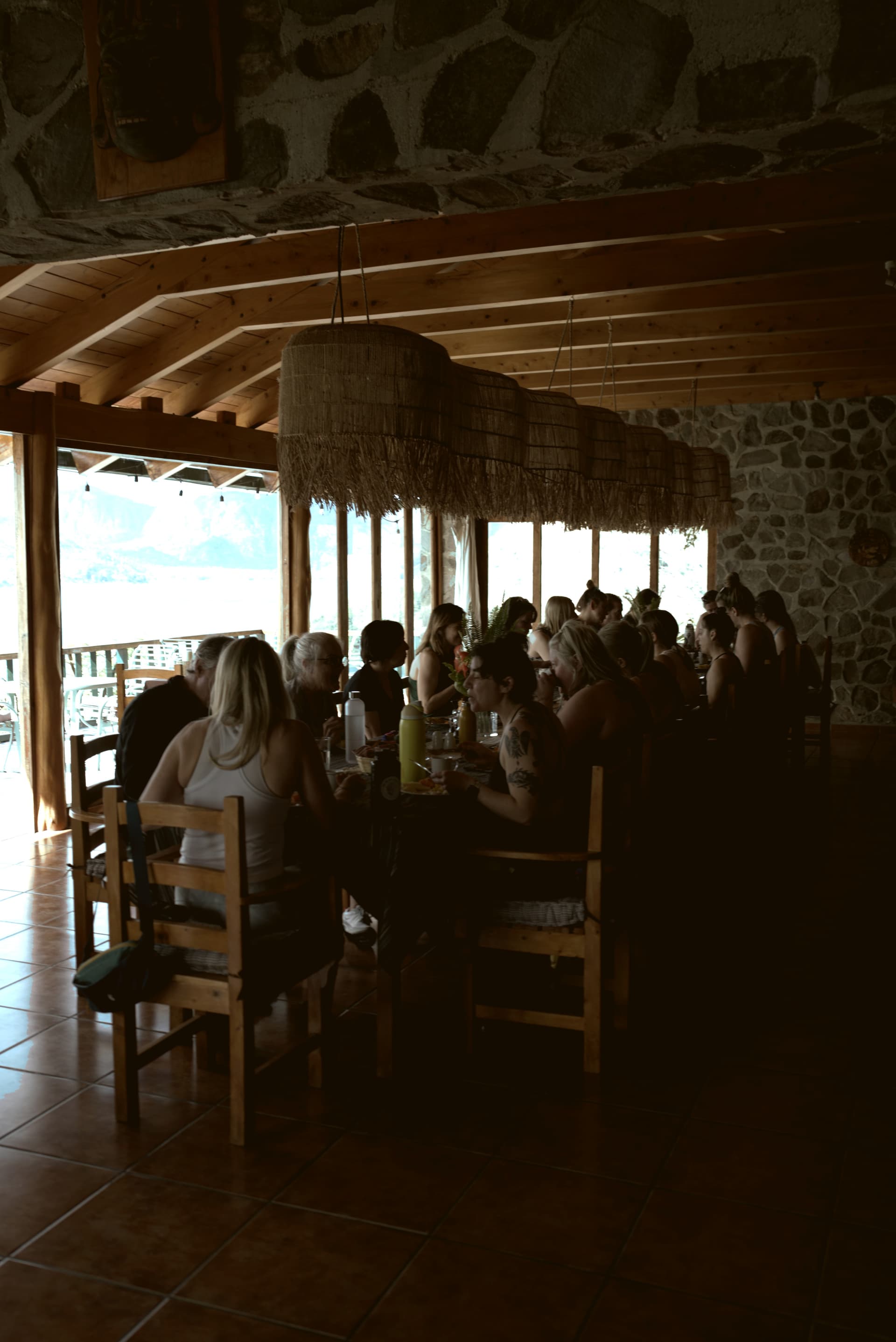 Group dining together at a long table with lake view