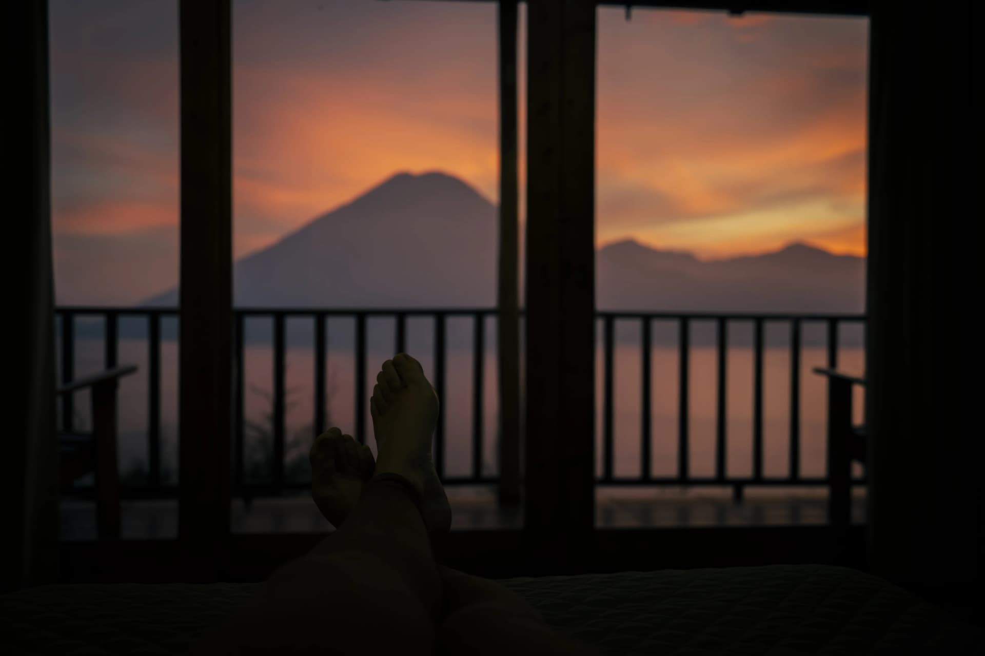 Afternoon storm clouds building over the volcanoes across Lake Atitlán in Green Season